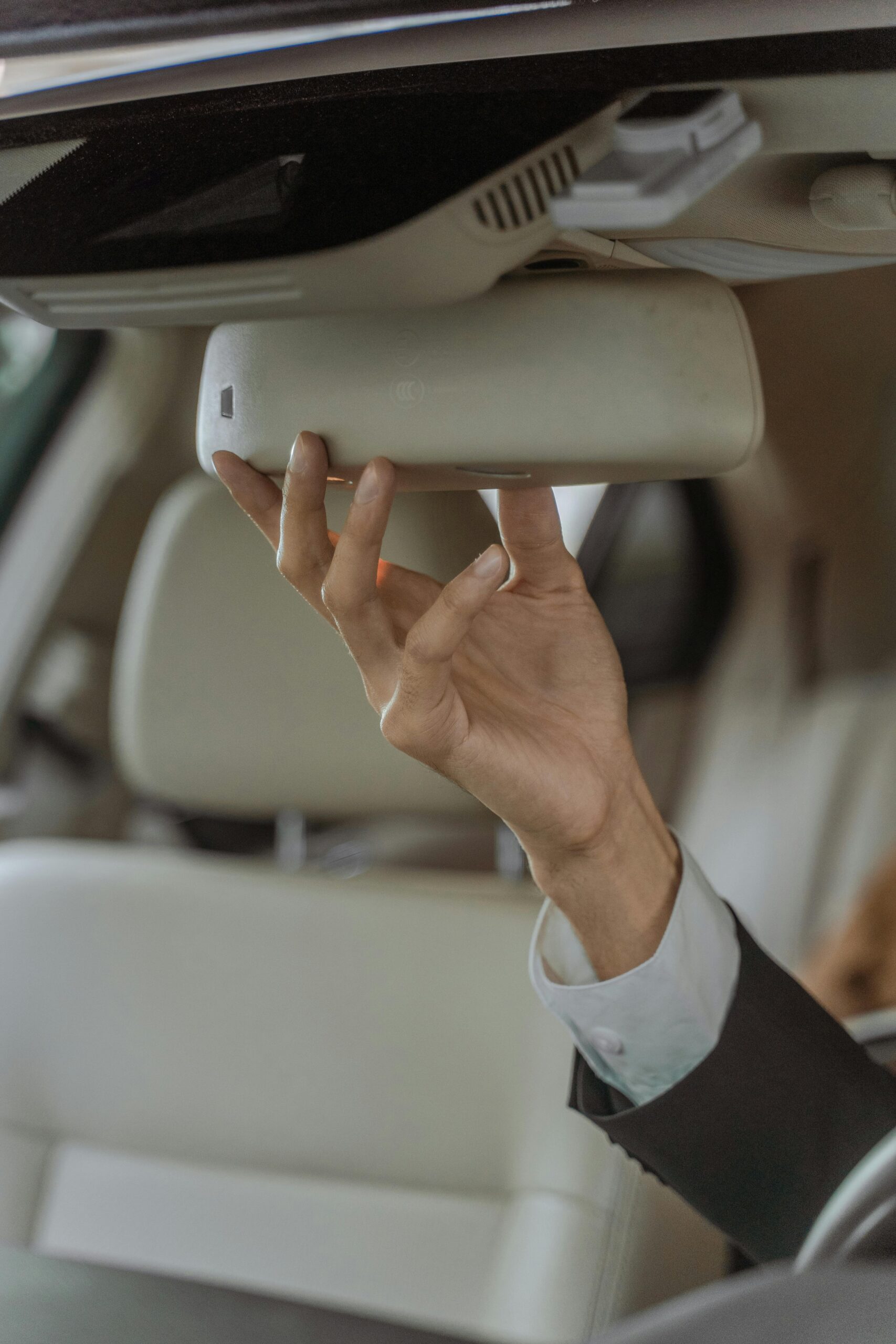 pexels-ron-lach-9519976 driver adjusting the car mirror